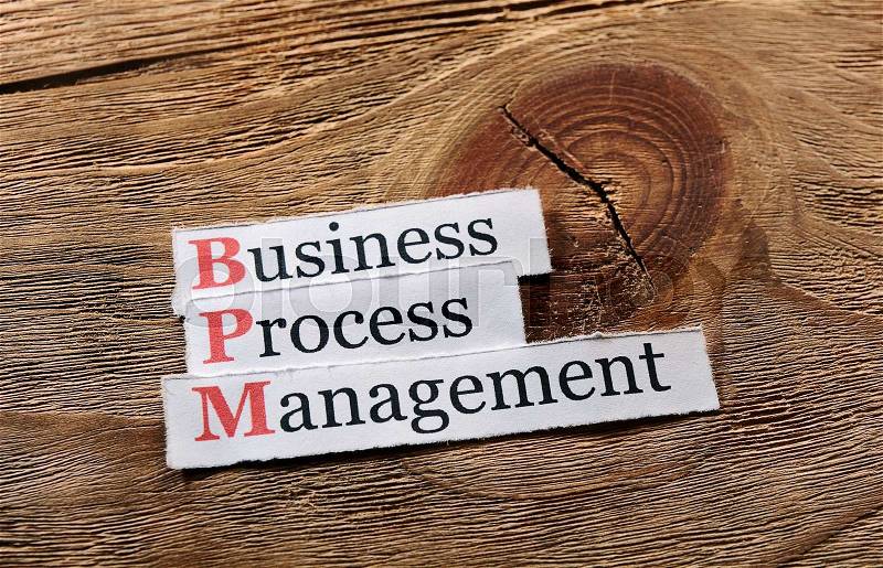 BPM business process management on paper ,wooden background, stock photo