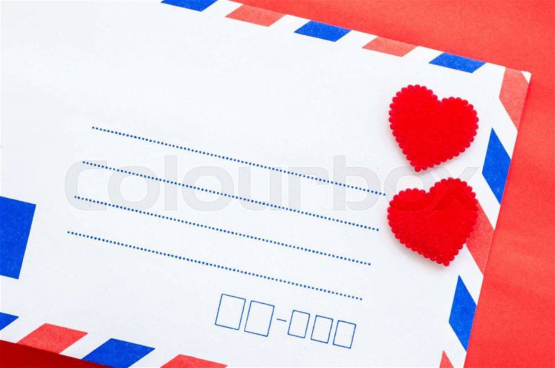 Vintage mail envelopes and red heart on red background, stock photo