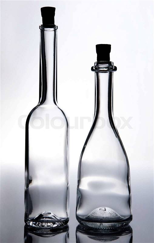 Old fashioned transparent empty wine bottles with cork, stock photo