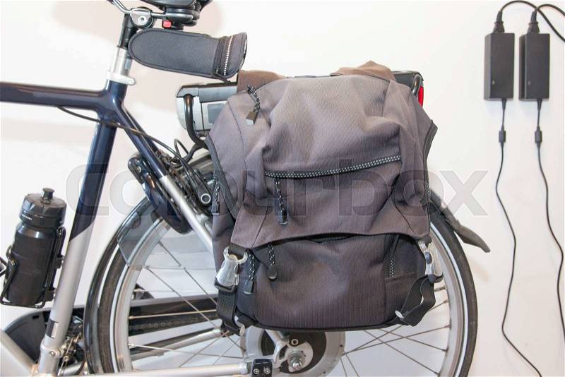 Electric bicycle charging, selective focus on cycle bag, stock photo