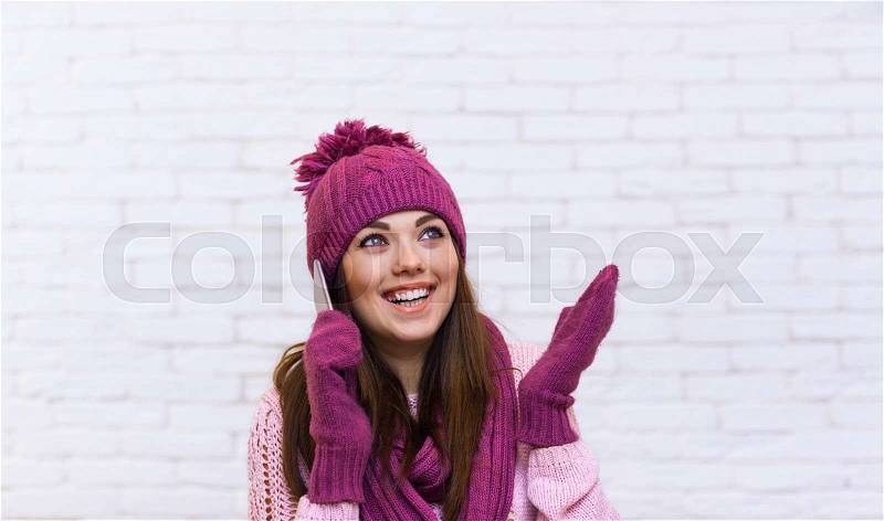 Attractive Teenage Girl Hand Gesture To Copy Space Cell Phone Call Smile Surprised Over White Brick Background, stock photo