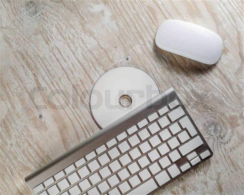 Wireless keyboard and mouse and white printable CD. Template for design presentations and portfolios. Top view, stock photo