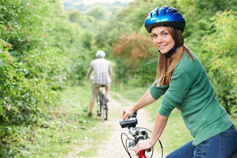 Young Couple Cycling Along Country Track, stock photo