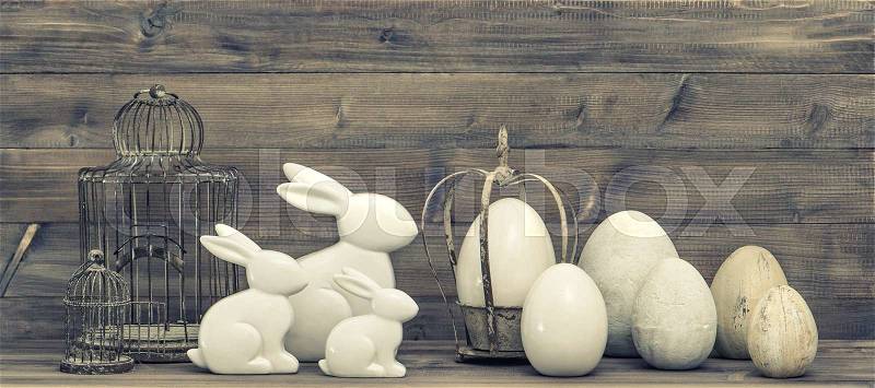 Easter bunny and easter eggs decoration. Vintage style toned picture, stock photo