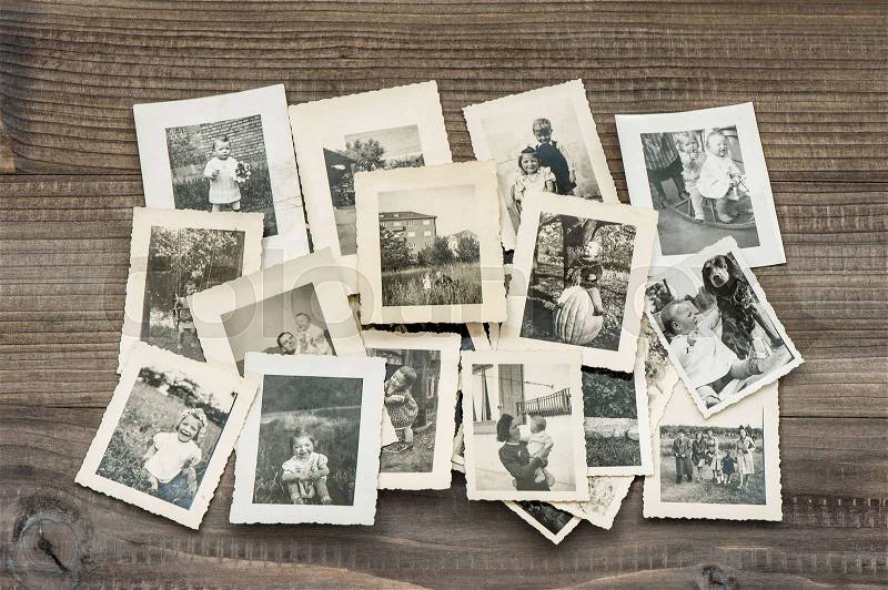 Old family photos on wooden table. Vintage pictures , stock photo