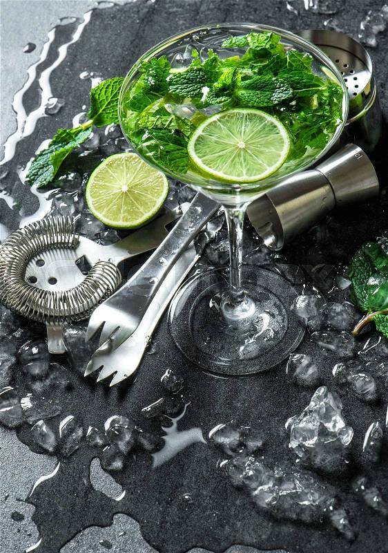 Cocktail drink with lime, mint and ice. Bar accessories, stock photo