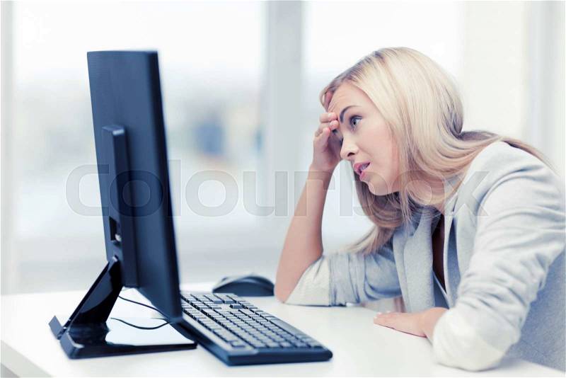 Picture of stressed businesswoman with computer at work, stock photo