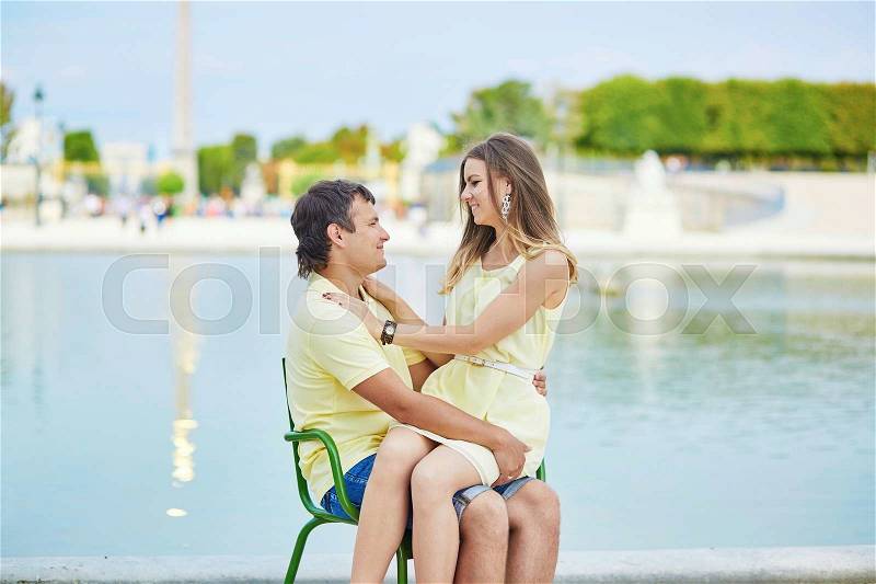 Beautiful young dating couple in Paris in the Tuileries garden, stock photo