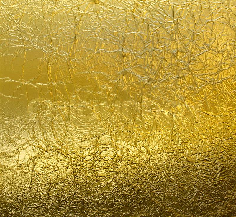 Wrinkled leaf gold foil pattern reflective texture background, stock photo