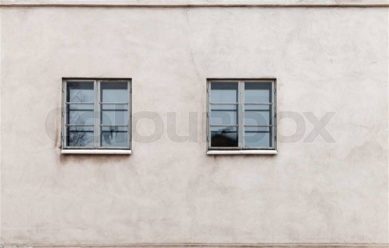 Two windows in modern gray concrete wall, detailed background photo texture, stock photo