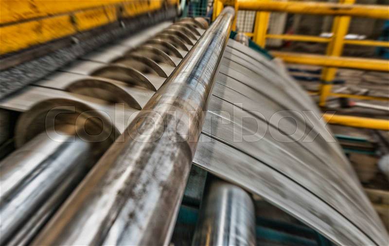 Cold rolled steel coil on decoiler of machine in metalwork manufacturing, stock photo