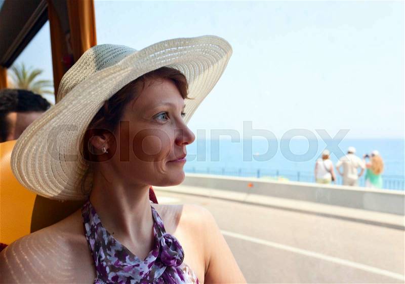 The woman in the bus looks out of the window , stock photo
