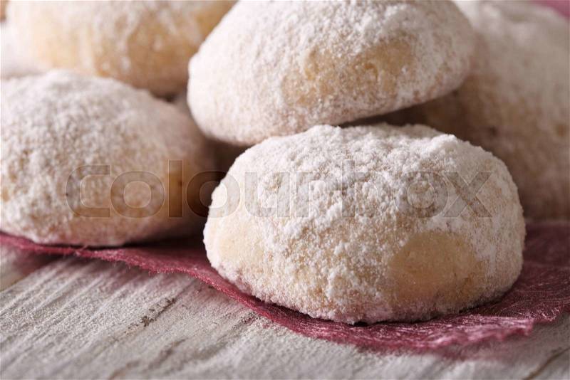 Polvorón cookies with powdered sugar macro on a wooden table. horizontal , stock photo