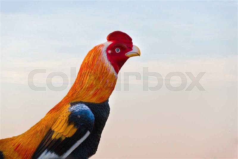 Silhouette of Big chicken statue at the urban on sunset time, stock photo
