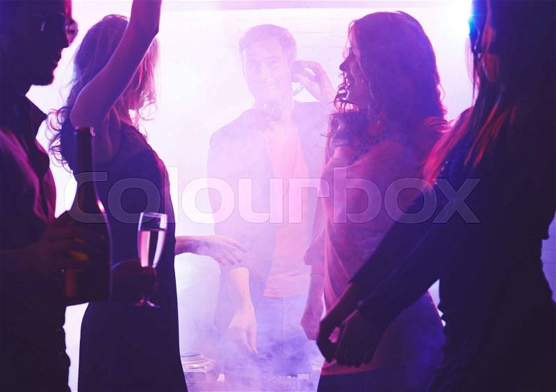 Young energetic friends dancing at party, stock photo