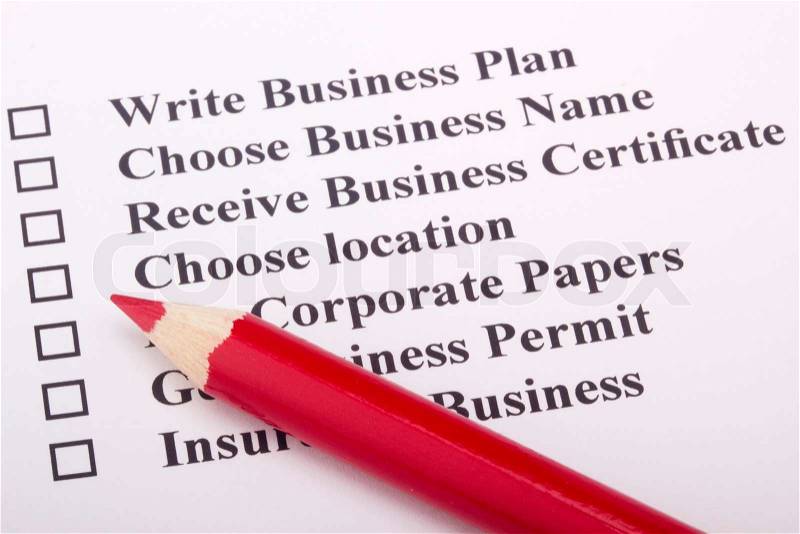 A red pencil laying on a paper with a checklist for starting a business, stock photo