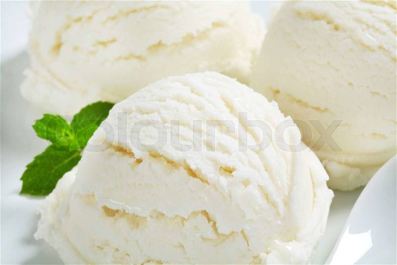 Scoops of white ice cream - lemon, vanilla or coconut flavor, stock photo