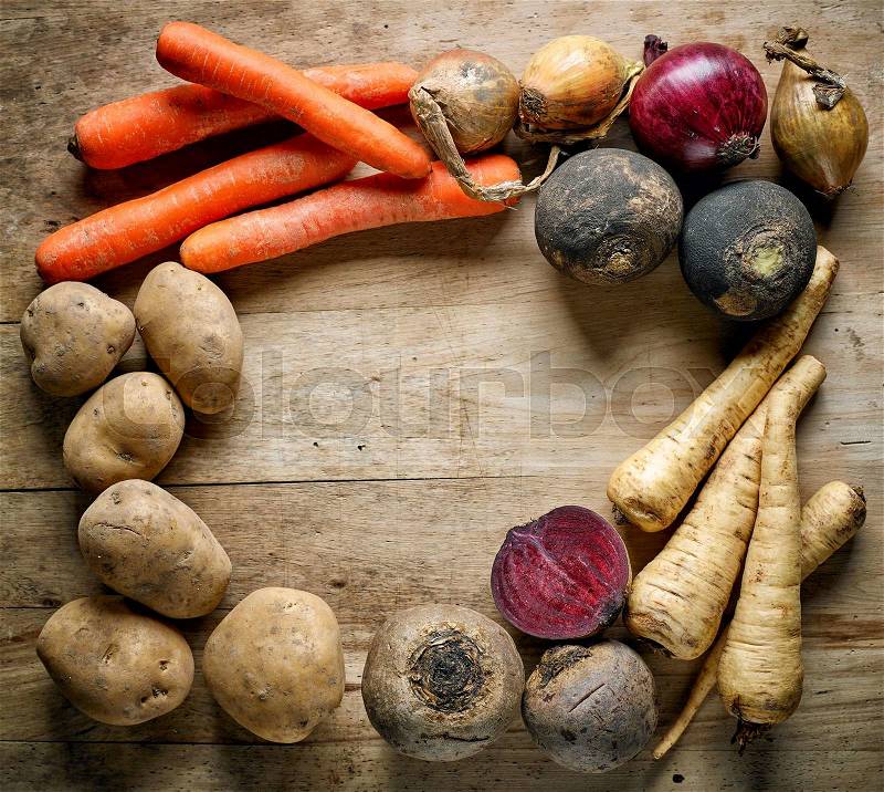 Various root vegetables on wooden table, top view, flat lay, stock photo