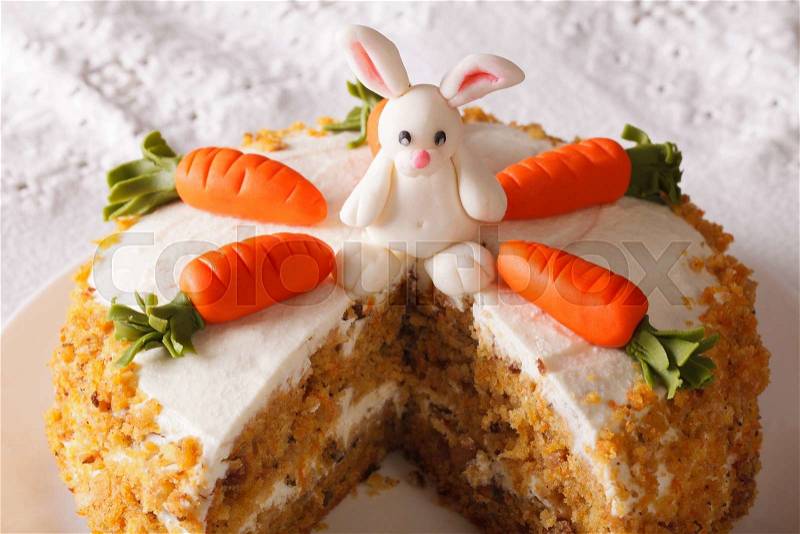 Cut a piece of carrot cake decorated with bunny close-up on the table. horizontal , stock photo