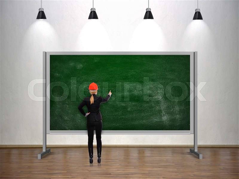 Engineer woman drawing on blank chalk board, stock photo