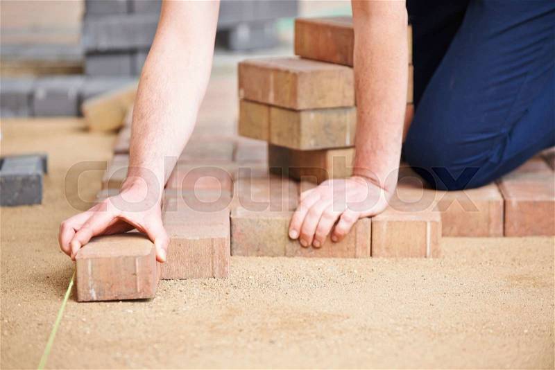 Man Laying Blocks For Patio, stock photo