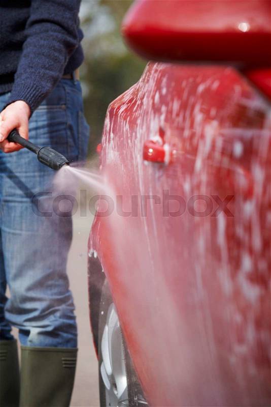 Man Cleaning Car With Pressure Washer, stock photo