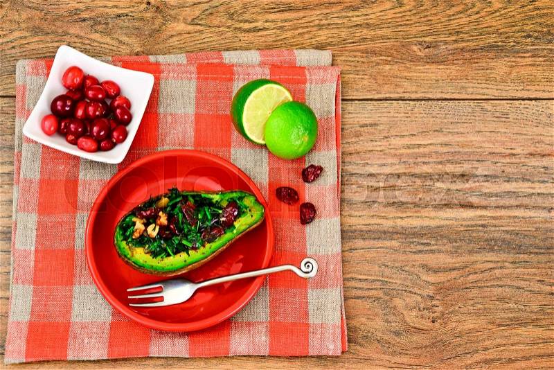 Avocado salad with herbs dill, parsley, cilantro, nuts and sun-dried cranberries Studio Photo, stock photo