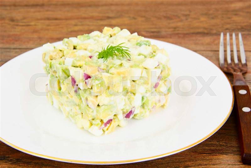 Salad with Avocado, Boiled Eggs, Red Onion and Mayonnaise Studio Photo, stock photo
