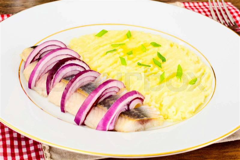 Mashed Potatoes with Herring and Red Pickled Onions Studio Photo, stock photo