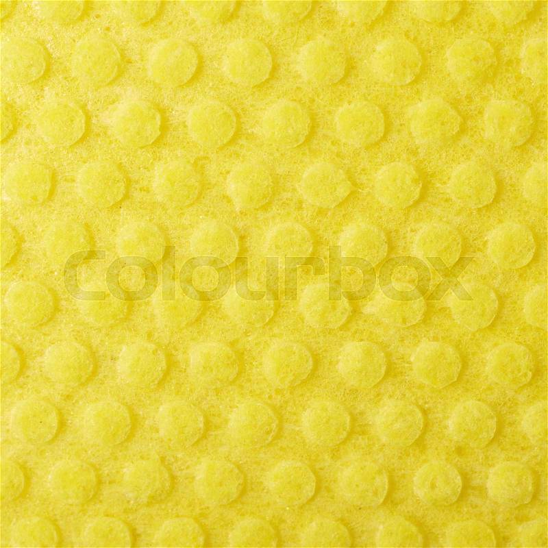 Yellow kitchen wipe cloth close-up fragment as a background texture, stock photo