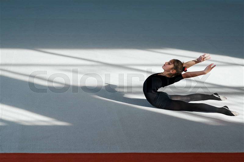 Girl doing backfold rhythmic gymnastics, stock photo