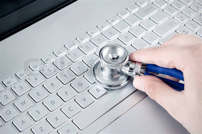 Diagnosis and repair of computers. Stethoscope on laptop, stock photo