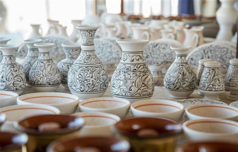 Bunch of different pattern clay jars and pots made by greek artists ready to be painted, stock photo