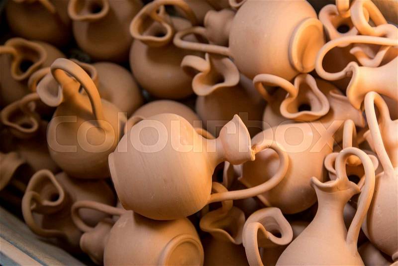 Box full of small brown clay jars made by greek artists, stock photo
