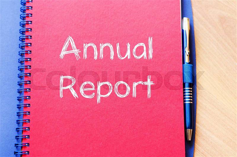 Annual report text concept write on notebook with pen, stock photo