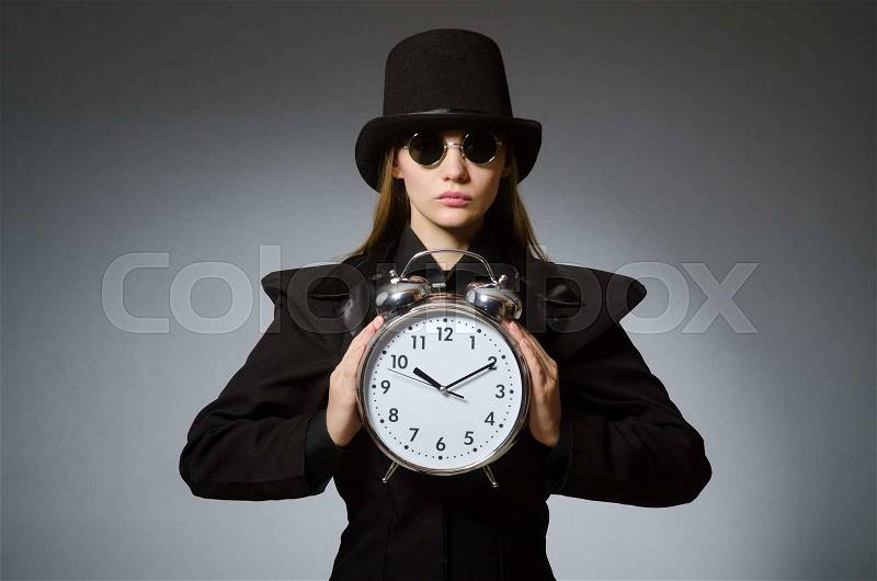 Woman with clock in business concept, stock photo
