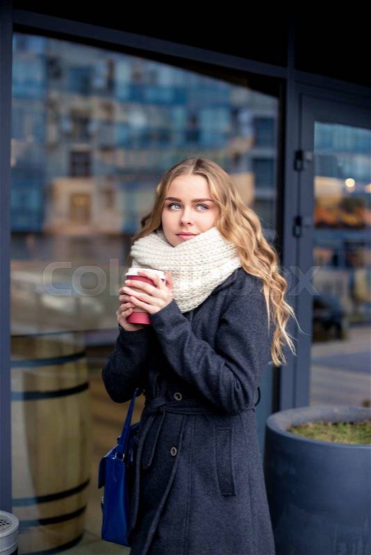 Businesswoman in a hurry to work with a cup of coffee. outdoor shot, stock photo