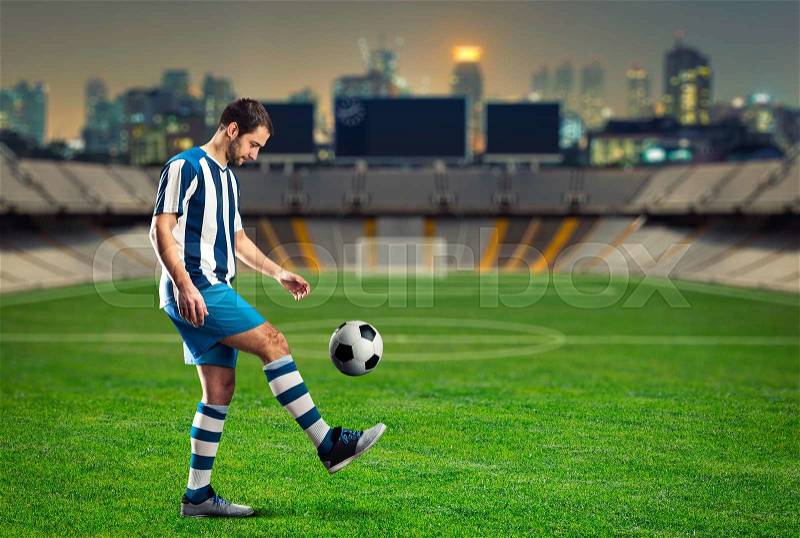 Football player training on the football ground, stock photo