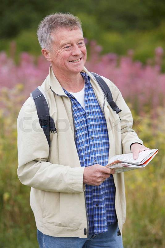 Senior Man Enjoying Hike In The Countryside, stock photo