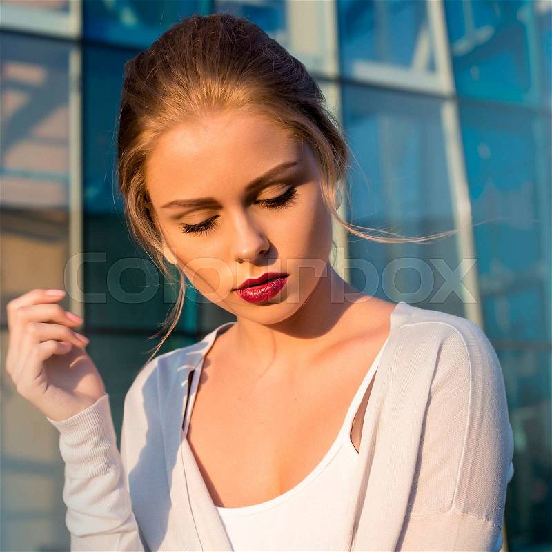 Sad woman looking down. portrait on a street. summer time, stock photo