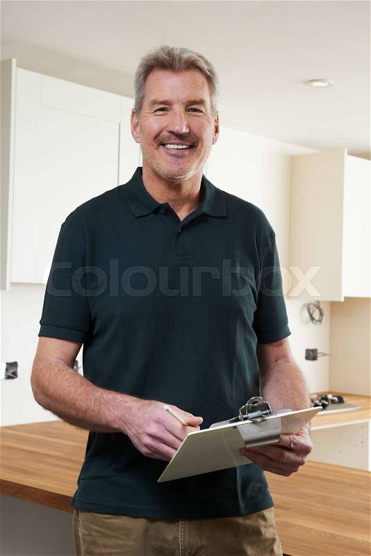 Carpenter Installing Luxury Fitted Kitchen, stock photo