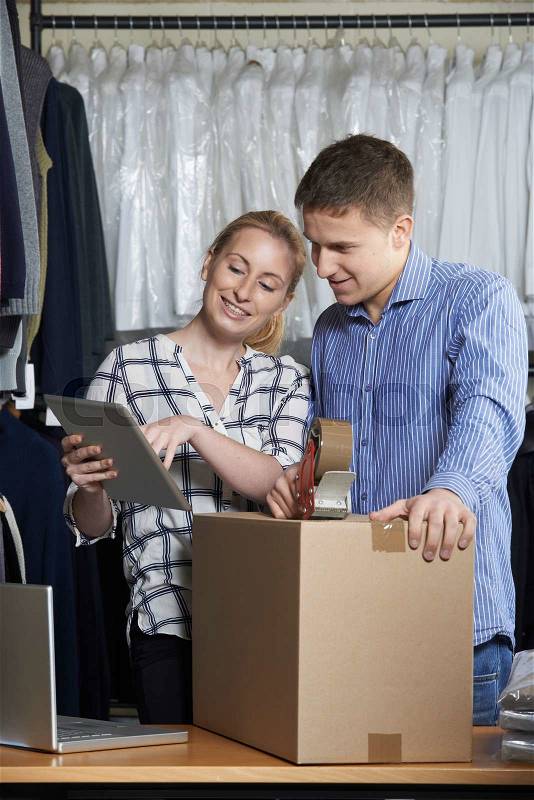 Couple Running Online Clothing Store Packing Goods For Dispatch, stock photo