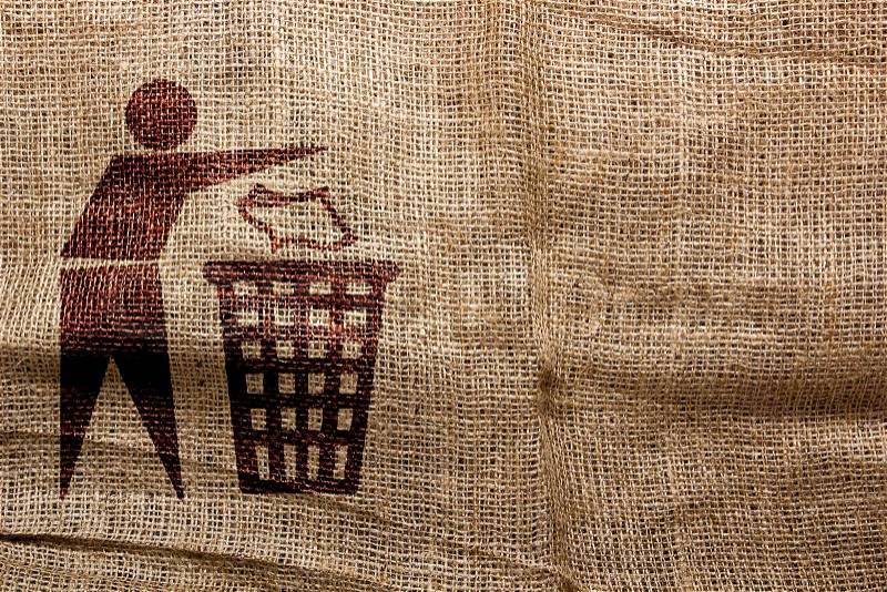 Stamp on sackcloth, throw away the trash. Industrial symbolism, stock photo