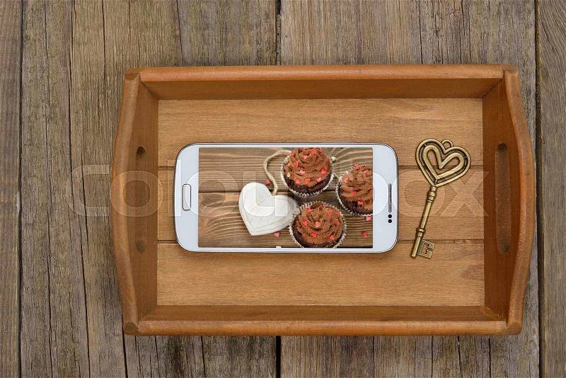 Tray, telephone and key on wooden background, Valentine\'s Day concept, stock photo
