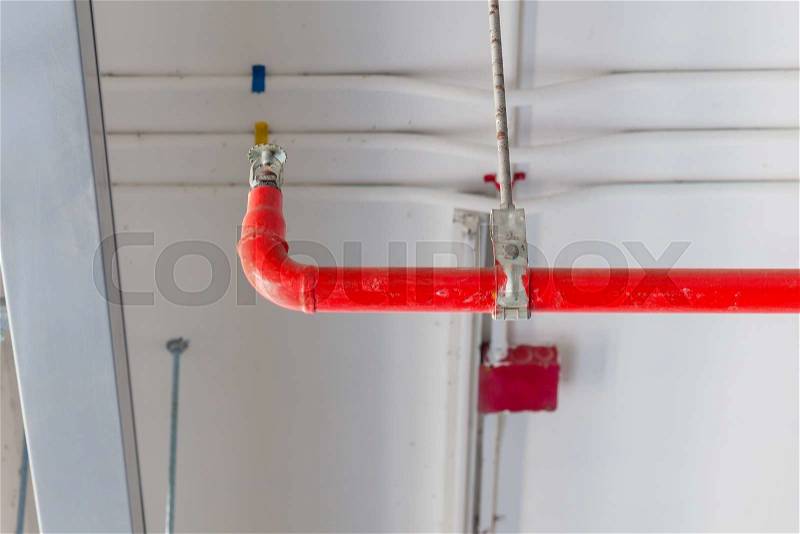Fire sprinkler and red pipe installed on ceiling for safety concept, stock photo