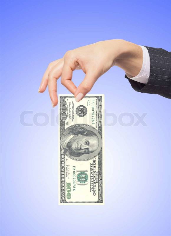 Hand holding money dollars over blue background, stock photo