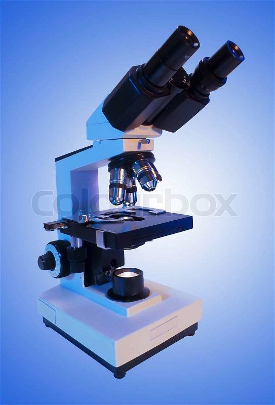 Laboratory metal microscope over blue background, stock photo