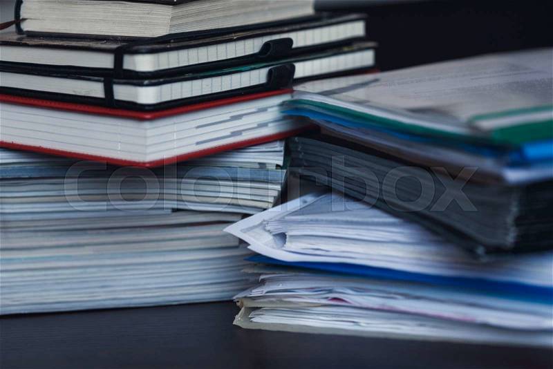 Accounting and taxes. Large pile of magazine, notebook and books closeup, stock photo