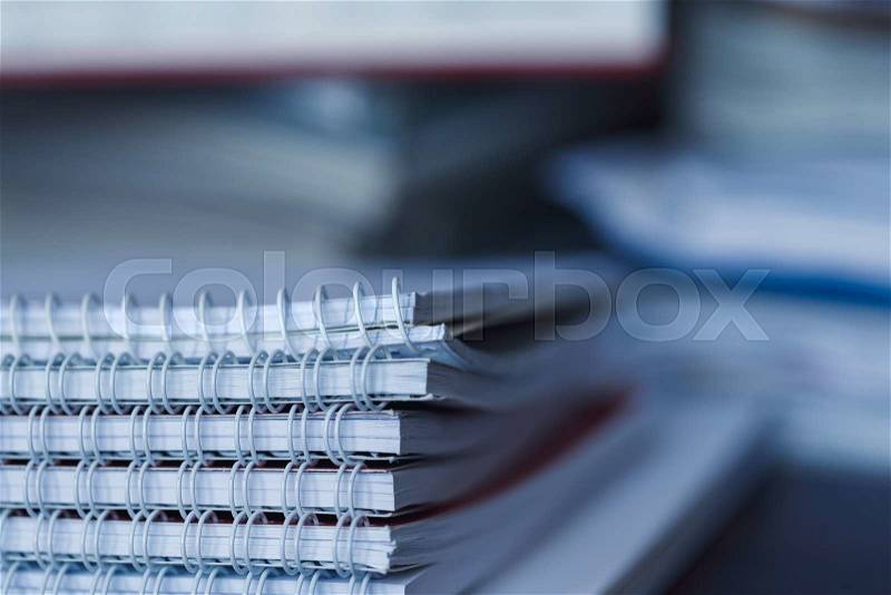 Accounting and taxes. Large pile of magazine, notebook and books closeup, stock photo