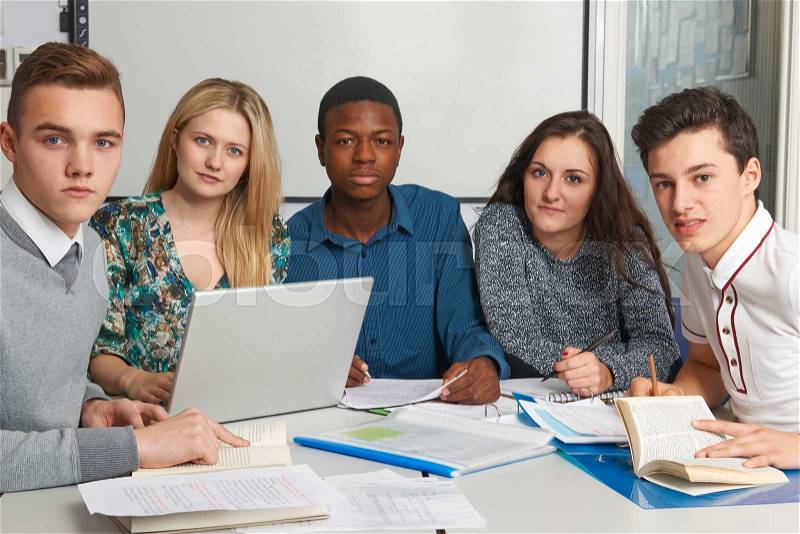 Group Of Teenage Pupils Working In Classroom, stock photo